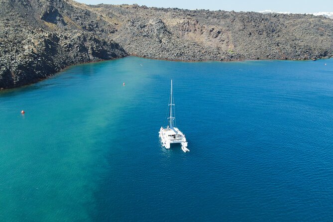 Full Day Santorini Catamaran Private Cruise with meal and transfer - Faros lighthouse and the Indian head rock: a quick geometry lesson