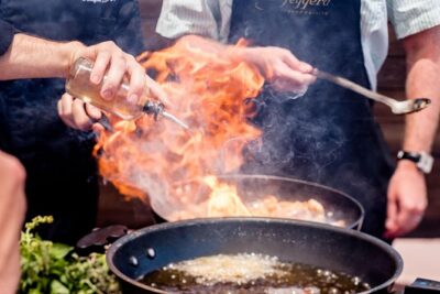 Private Santorini Cooking, Tasting, and Wine Experience - The cooking class at an open-air restaurant with a real chef