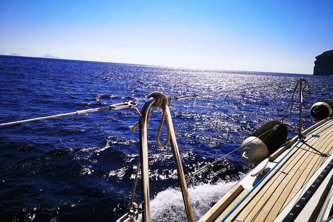 Sailsational Luxury Santorini Catamaran Sunset Cruise with Dinner - Stop 1: Red Beach time on volcanic coast