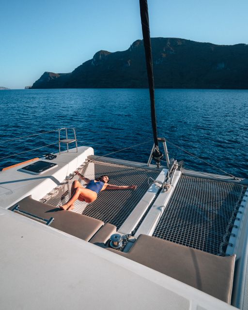 Santorini: All-Inclusive Private Catamaran Experience - Rolling past Santorini icons: Red Beach and White Beach viewpoints