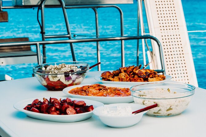 Santorini Caldera Gold Day Cruise with BBQ on board and Open Bar - Red Beach: famous color, short swim window