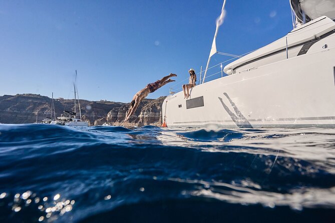 Santorini: Caldera Private Catamaran Cruise with Meal & Drinks - Mesa Pigadia: a black-sand beach where swimming is the point