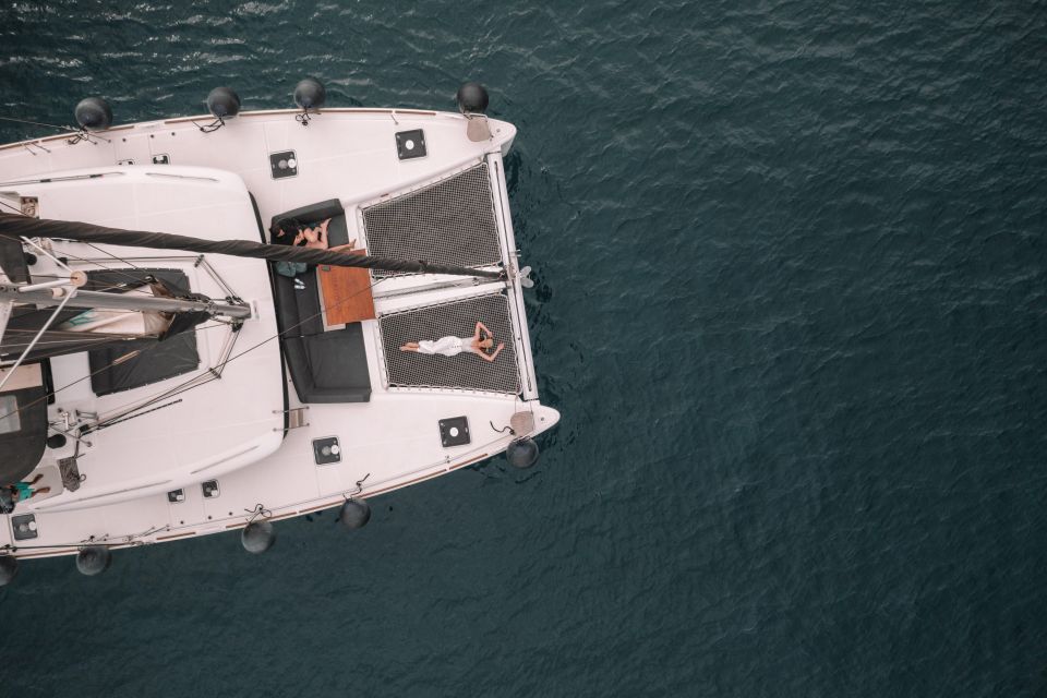 Santorini Catamaran Cruise with Swimming, Meal and Open Bar - Akrotiri Lighthouse pass: a photo-friendly breather
