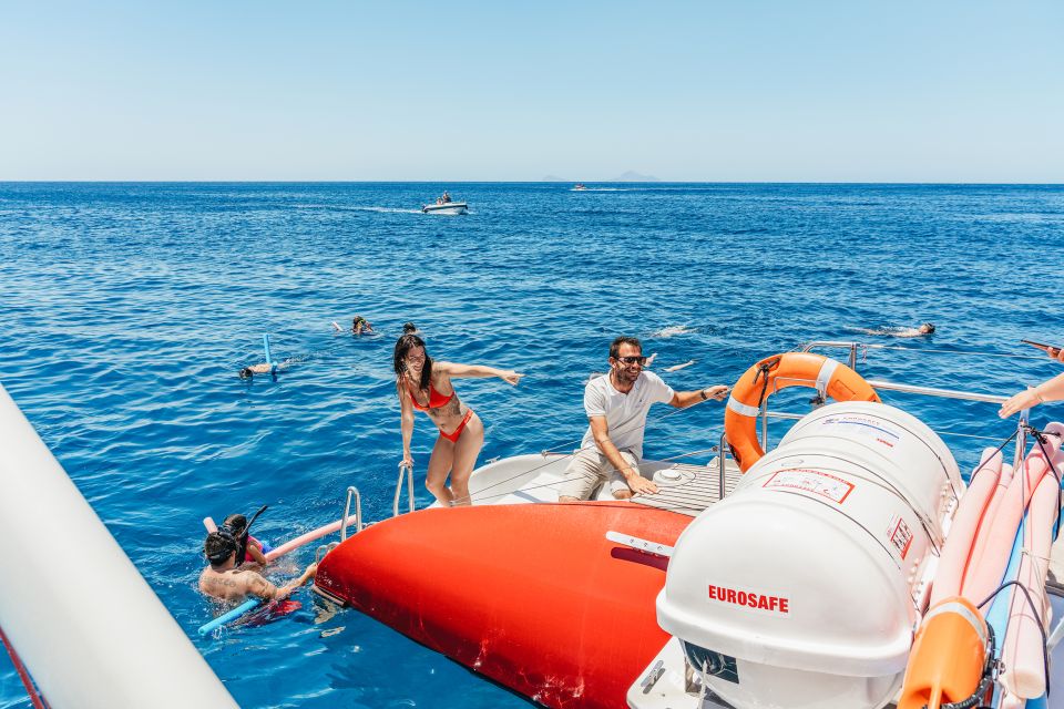 Santorini: Catamaran Tour with BBQ Dinner, Drinks, and Music - A 5-hour catamaran that turns the Caldera into your playground