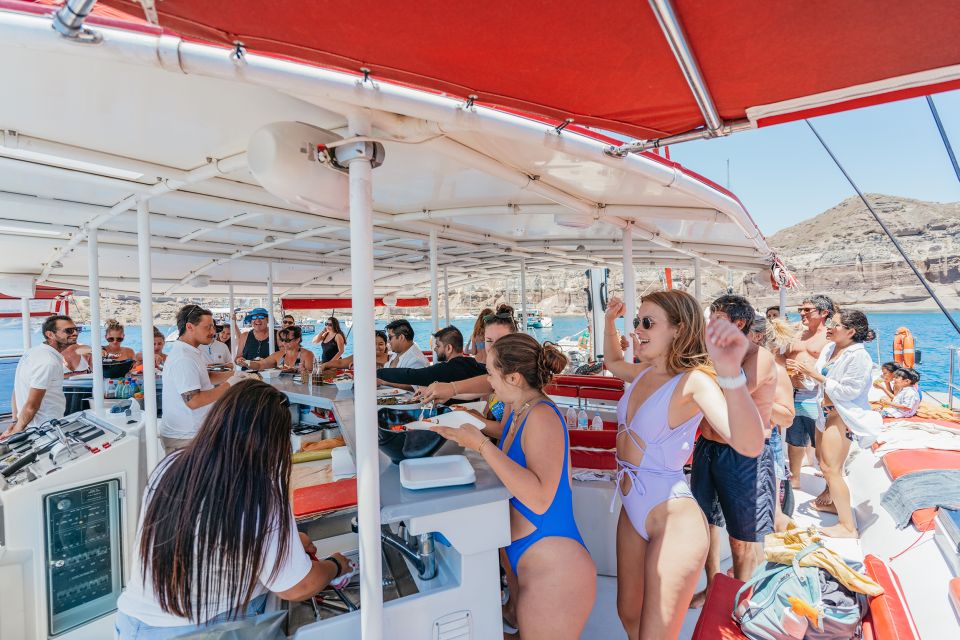 Santorini: Catamaran Tour with BBQ Dinner, Drinks, and Music - White Beach cliffs from the sea: pretty, but don’t overplan it