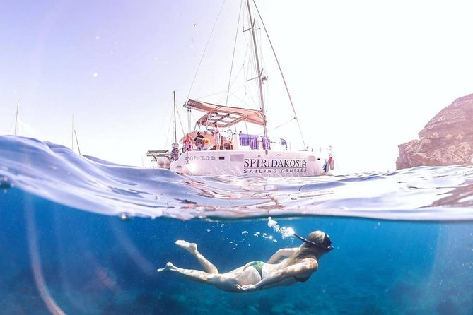 Santorini Classic Catamaran Cruise with BBQ, Drinks and Transfers - Day vs sunset: dress smart so the wind doesn’t steal your comfort