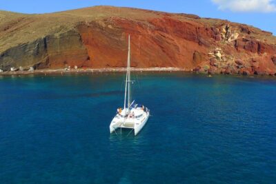 Santorini Full Day Catamaran Private Cruise incl. Meal, Drinks & Free Transport - Red Beach and White Beach: Volcanic Color With Snorkeling-Friendly Stops