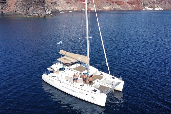 Santorini Gold Catamaran Cruise with BBQ, Drinks and Hotel Pickup - Red Beach, White Beach, and Akrotiri’s Venetian Lighthouse stop