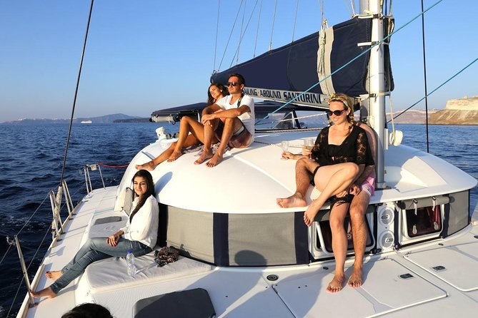 Santorini Half Day Catamaran Private Cruise incl. Meal, Drinks & Free Transport - Private Catamaran + Hotel Pickup: The Hassle-Free Start
