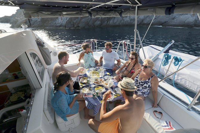 Santorini Half Day Catamaran Private Cruise incl. Meal, Drinks & Free Transport - Red Beach Near Akrotiri: Volcanic Color and Real Snorkeling Time