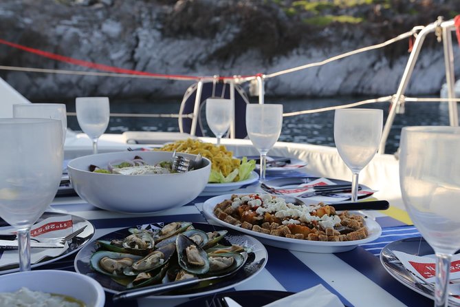 Santorini Half Day Catamaran Private Cruise incl. Meal, Drinks & Free Transport - Mesa Pigadia Beach (Black Rock): A Secluded Sand-and-Stone Break