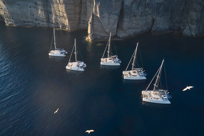 Santorini: Luxury Catamaran Cruise with Fresh Fish BBQ & Drinks - The Volcano and Sulfur-Warm Water Area: Caldera Views From the Boat