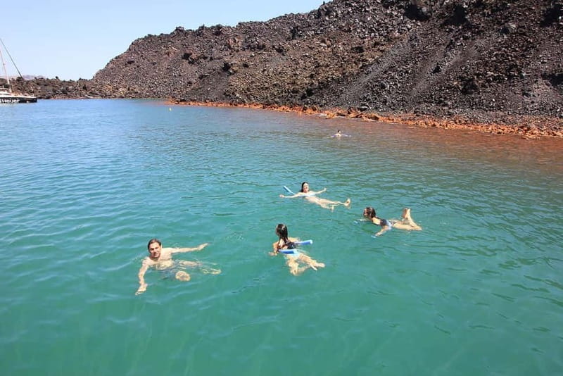Santorini: Luxury Catamaran Cruise with Lunch, BBQ & Drinks - Akrotiri Lighthouse area and the rock formations: where the Caldera turns dramatic