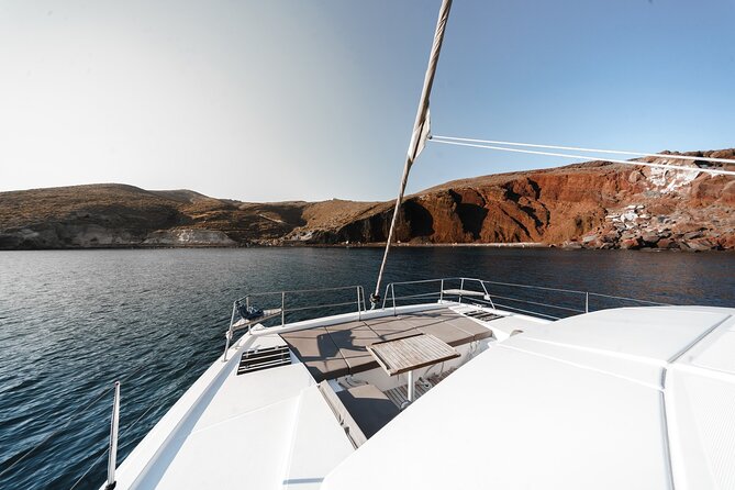 Santorini Luxury Catamaran Private Cruise - Sailing the South Coast and Caldera Highlights: Red and White Beach, Caves, Lighthouse, and Indian Rock