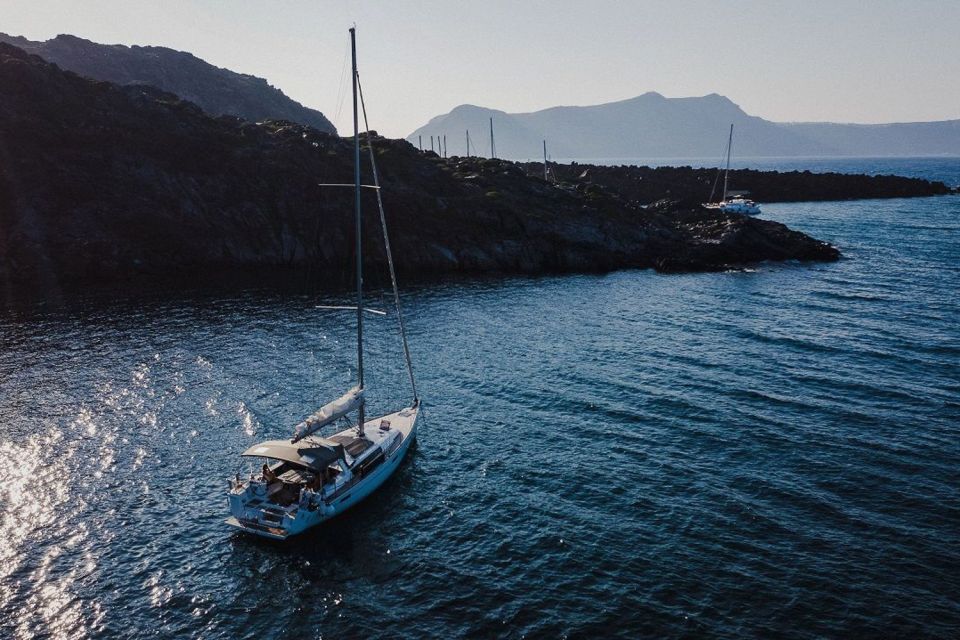 Santorini: Private Caldera Sailing Trip with Open Bar & Meal - Black Mountain coves: the hidden-feeling part of the caldera