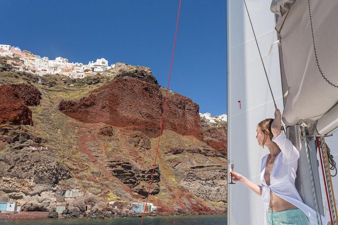 Santorini Private Catamaran Cruise with BBQ, Open Bar & Transfers - Indian Rocks and cliffside towns: seeing Santorini from sea level