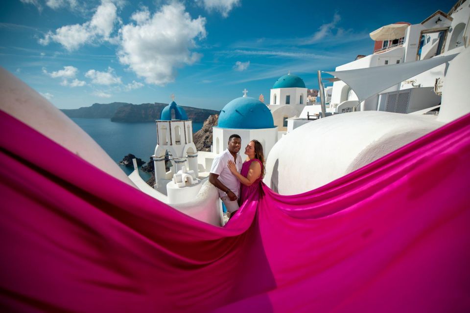 Santorini: Unique Flying Dress Photoshoot Experience - Oia blue domes are the real star of the flying dress look